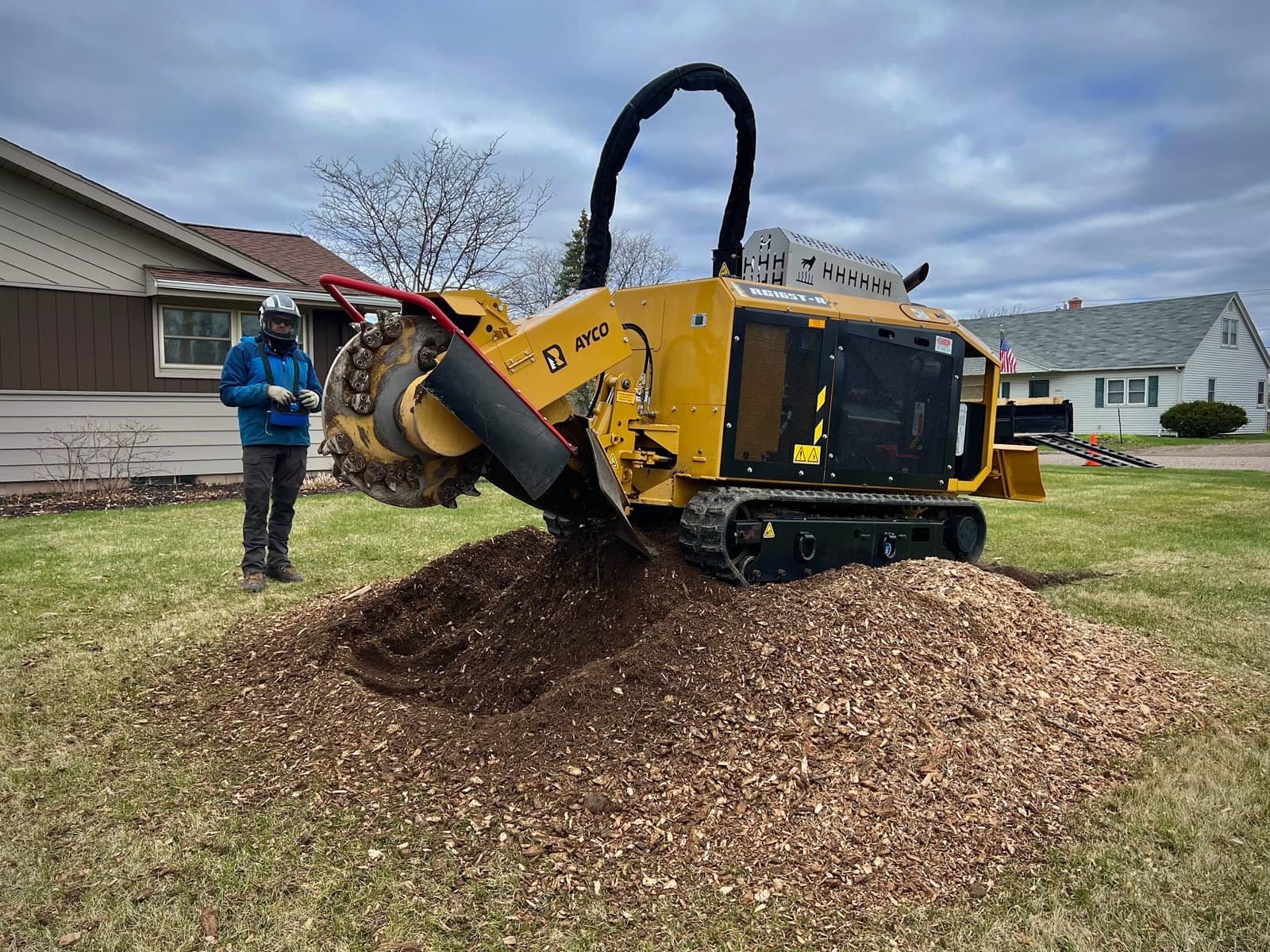 Stump grinder beside a mound of wood chips.